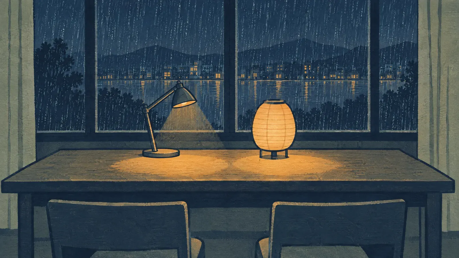 Metal desk lamp and paper lantern on a table at night